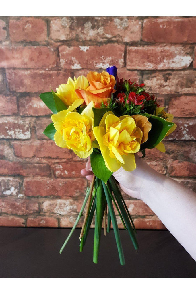 The perfect little gift to brighten someone's day. A cute handful of seasonal flowers arranged into a miniature posy. Beautifully roll wrapped in Kraft paper sent with a gift card containing your own personal message, with a water source to ensure freshness. Medium handful size shown in picture. Florist Wellington, Kilbirnie Wellington , Lyall Bay Florist