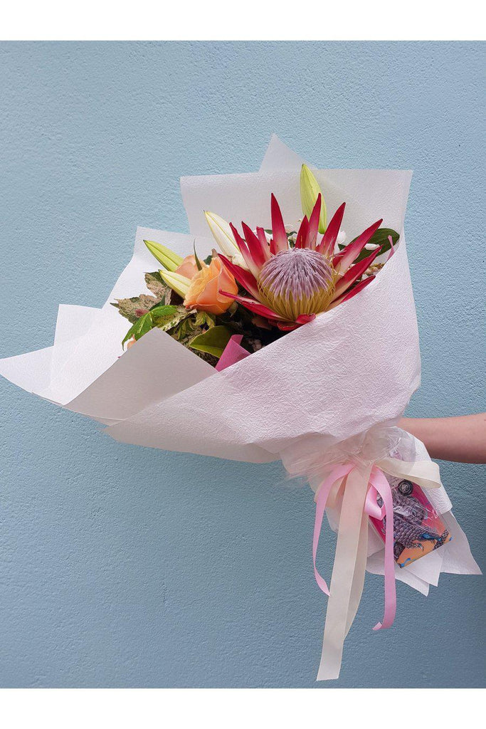 We all need a treat from time to time & this is the perfect treat. A beautiful florist choice mix of seasonal blooms with a Yummy The Wellington Chocolate factory bar beautifully attached to the wrap.