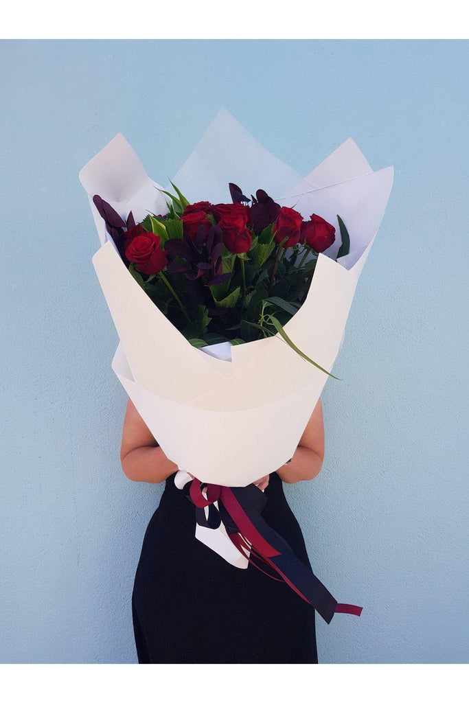This Bouquet is made from 12 long steamed Red Roses, arranged with a lush mix of foliage,  beautifully wrapped, sent with a gift card containing your own personal message, and wet wrapped on the stems’ ends to ensure freshness.