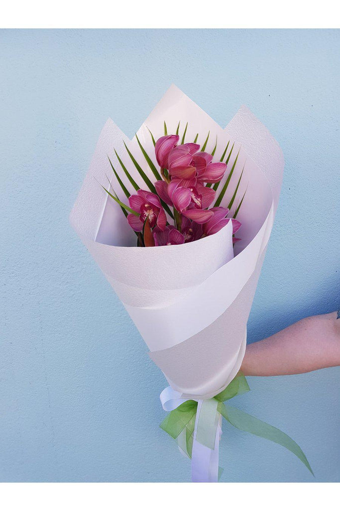 This single stem Orchid is beautifully wrapped, sent with a gift card containing your own personal message, and wet wrapped on the stems’ ends to ensure freshness.