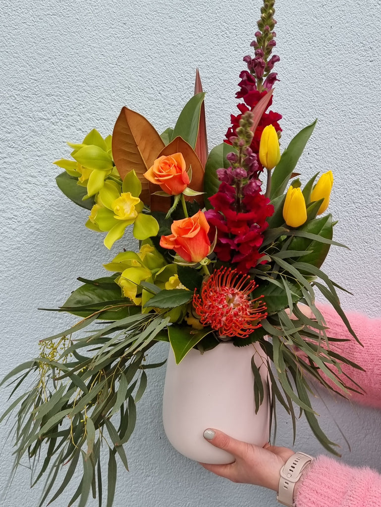 All our favourite market fresh bright blooms beautifully presented in a white vase to make a stunning statement.