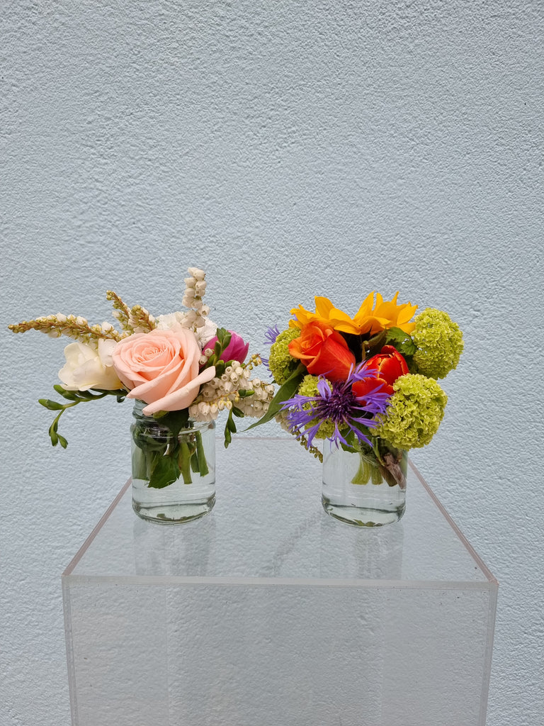 A 'Cutie Patootie' glass jar of fresh blooms.  This small handful of flowers is beautifully presented in a small glass jar, in a small carry bag, sent with a gift card containing your own personal message, and a small amount of water in the vase to ensure freshness.  Kilbirnie Florist, Wellington Florist